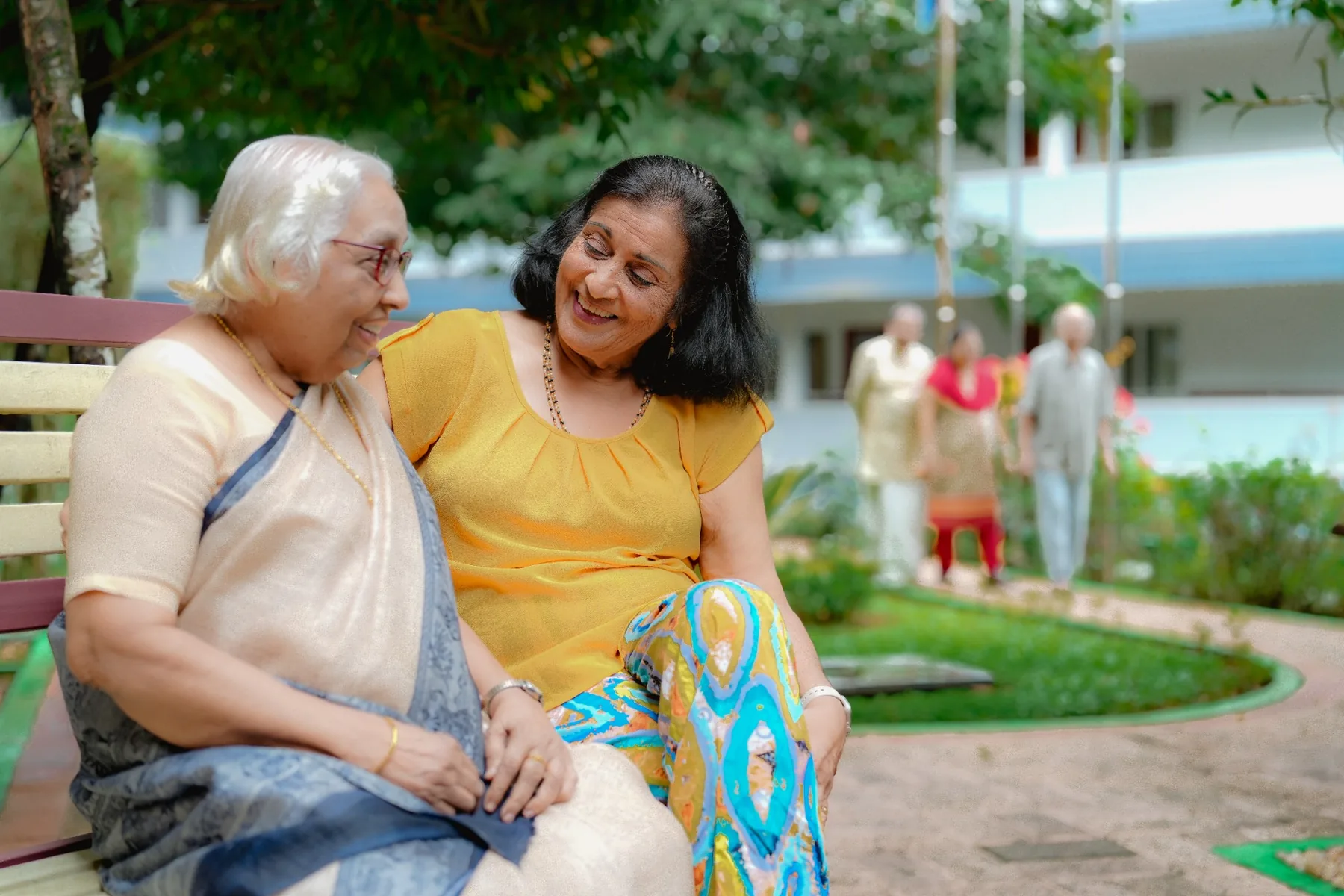 Senior friends sharing a joyful moment in the garden